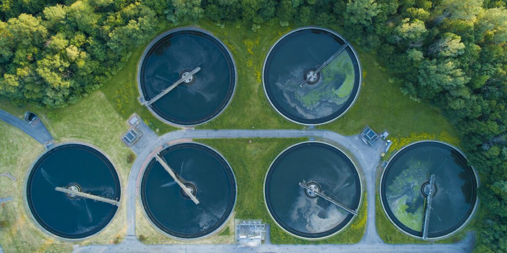 Aerial view of a city's waste management sewage and water treatment plants. Waste water purification.